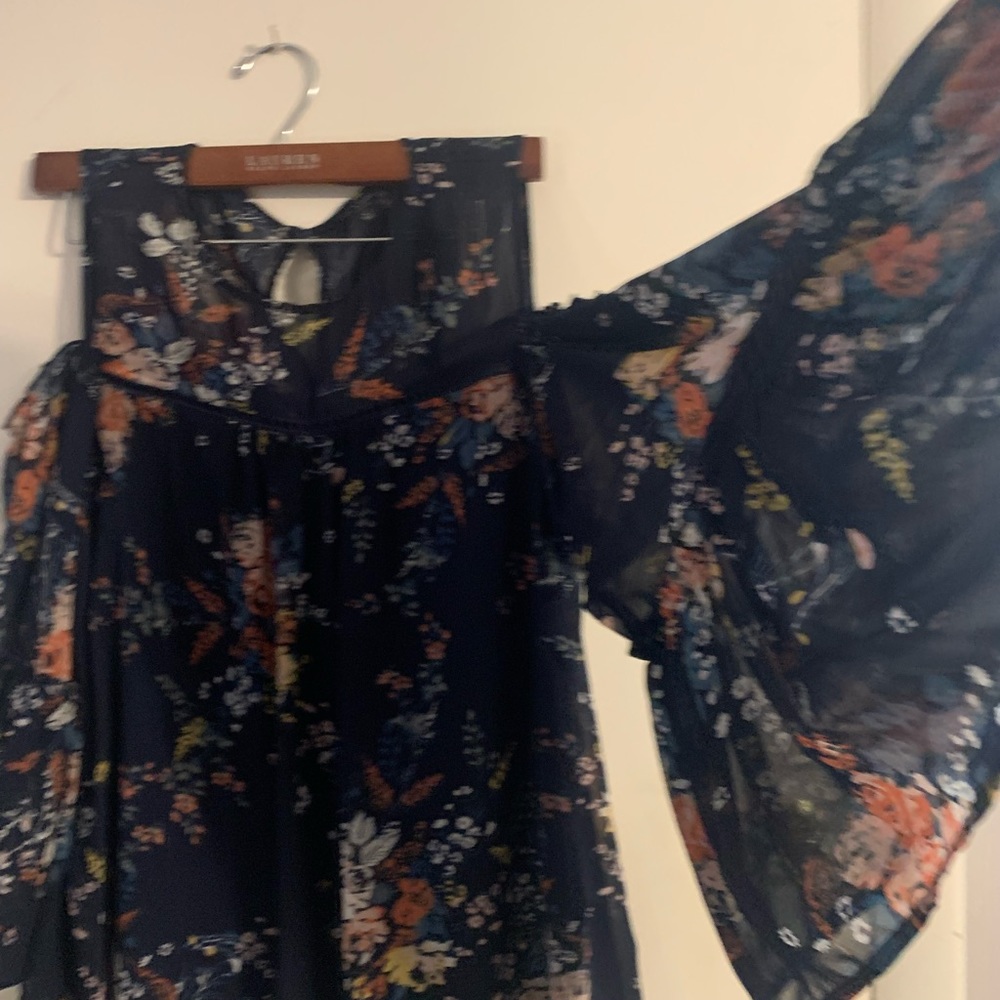 Cut out shoulder navy and floral blouse.
